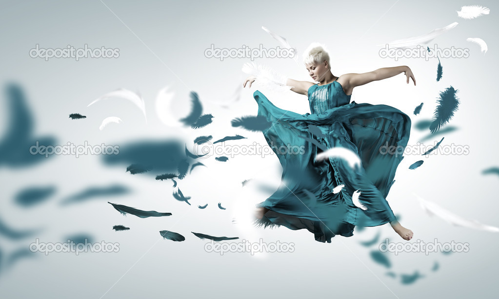 Carefree woman jumping high