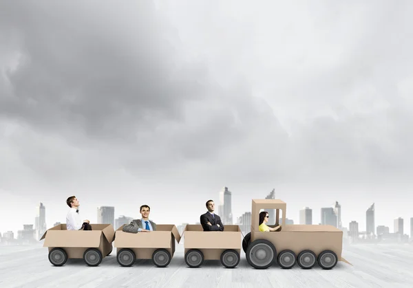 Business people riding carton train — Stock Photo, Image