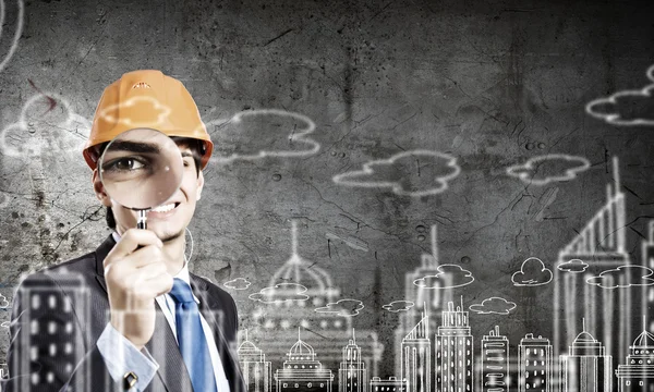 Architect looking in magnifying glass — Stock Photo, Image