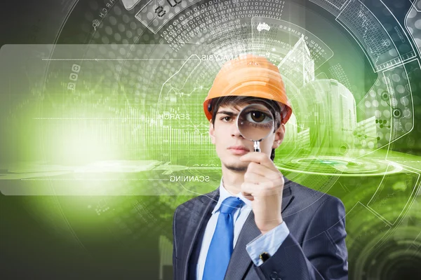 Engineer looking in magnifying glass — Stock Photo, Image