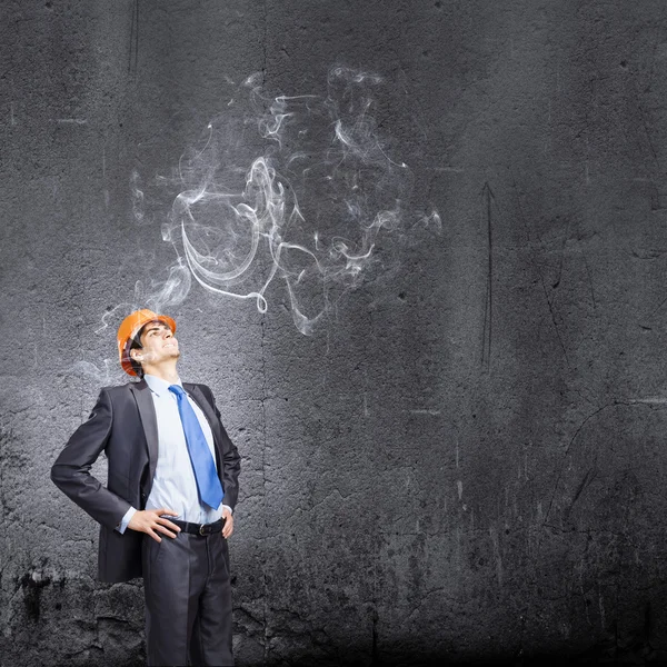 Thoughtful man in hardhat — Stock Photo, Image