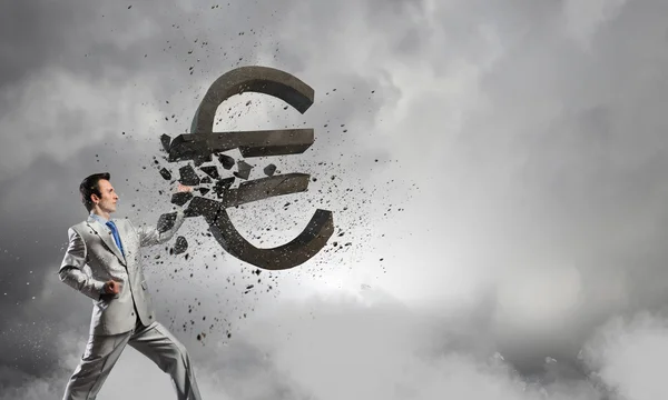 Businessman breaking stone euro symbol — Stock Photo, Image