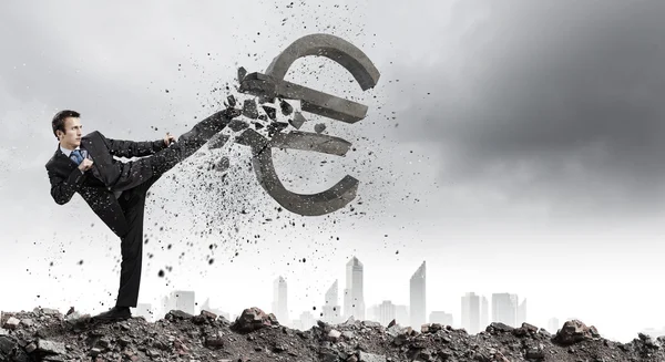 Businessman breaking stone euro symbol — Stock Photo, Image