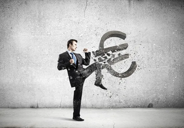 Businessman breaking stone euro symbol — Stock Photo, Image