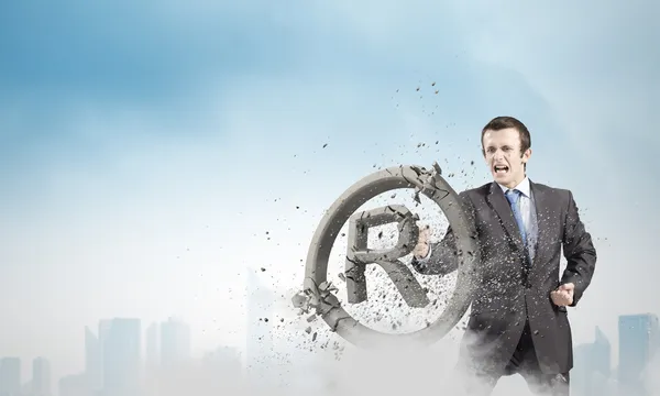 Businessman crashing stone trademark — Stock Photo, Image