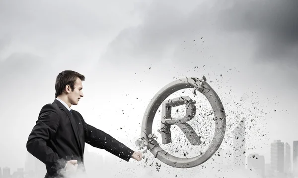 Businessman crashing stone trademark — Stock Photo, Image