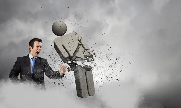 Businessman fighting with stone opponent — Stock Photo, Image