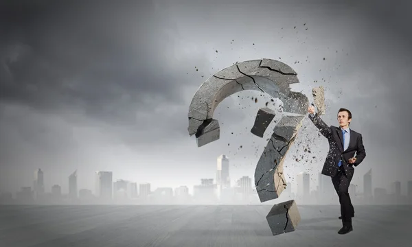 Businessman breaking stone question mark — Stock Photo, Image