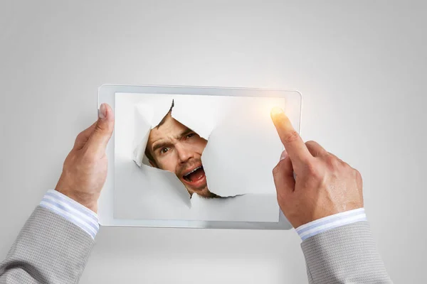 Male face through the hole in paper — Stock Photo, Image