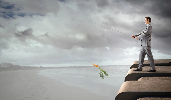 Businessman fishing with rod — Stock Photo, Image