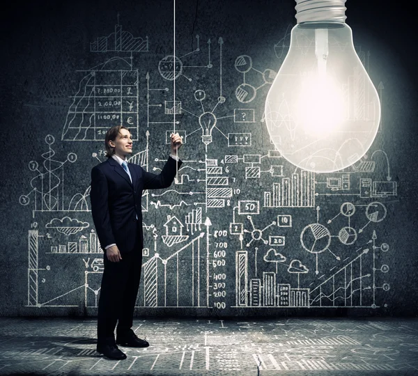 Businessman and big light bulb — Stock Photo, Image