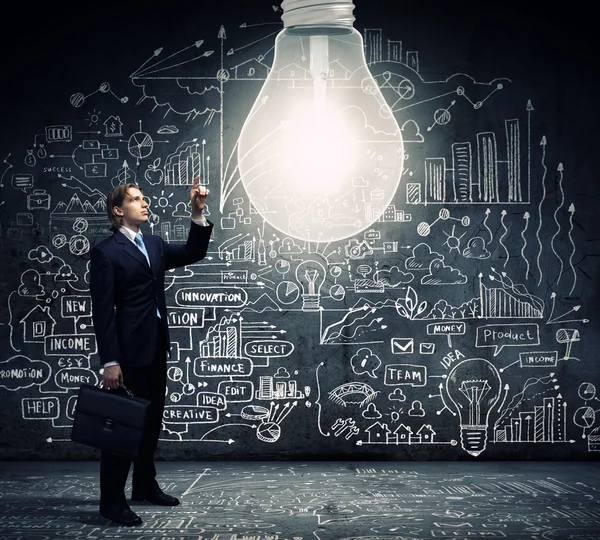 Businessman and big light bulb — Stock Photo, Image