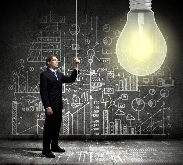 Businessman and big light bulb — Stock Photo, Image