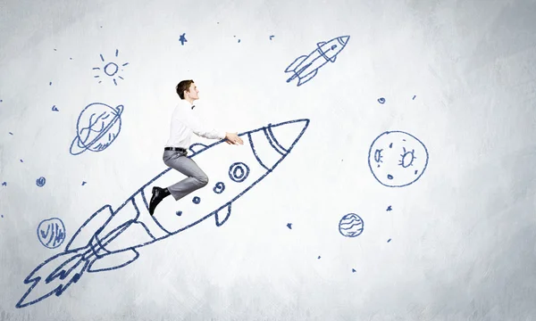 Businessman flying on drawn rocket — Stock Photo, Image