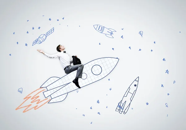 Businessman flying on drawn rocket — Stock Photo, Image