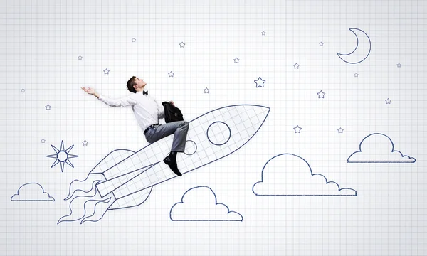 Businessman flying on drawn rocket — Stock Photo, Image