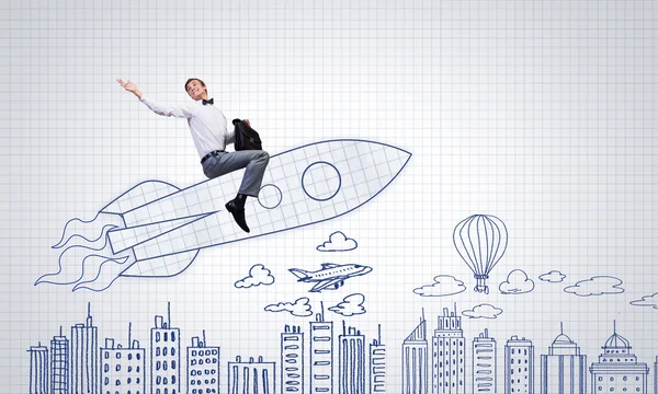 Businessman flying on drawn rocket — Stock Photo, Image