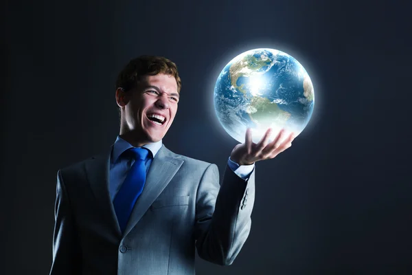 Businessman holding Earth planet in hand — Stock Photo, Image