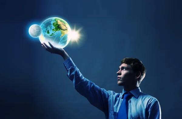 Businessman holding Earth planet in hand — Stock Photo, Image