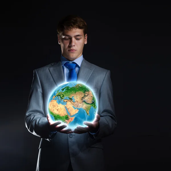 Businessman holding Earth planet in hand — Stock Photo, Image