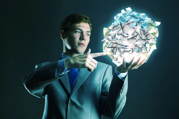 Businessman holding ball of money — Stock Photo, Image