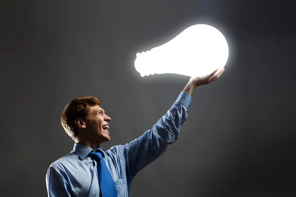 Man holding light bulb — Stock Photo, Image