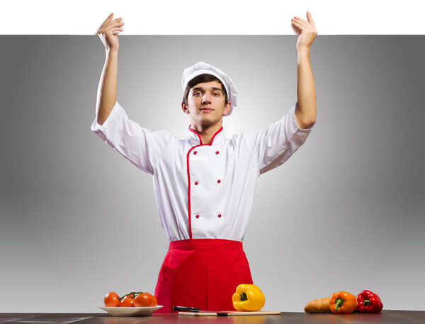 Cook holding blank banner