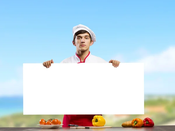 Cook segurando banner em branco — Fotografia de Stock