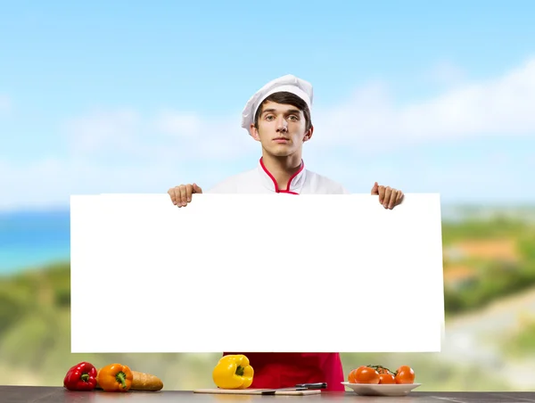 Cook segurando banner em branco — Fotografia de Stock