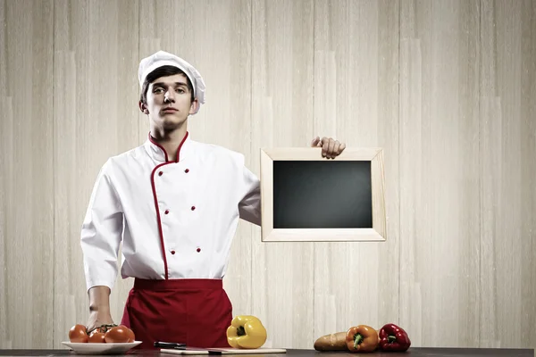 Cook holding blank chalk board — Stock Photo, Image