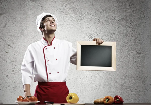 Cook holding blank chalk board — Stock Photo, Image