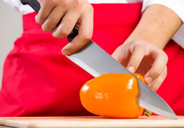Hands cutting pepper — Stock Photo, Image