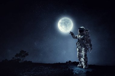 Keşfedilmemiş bir gezegende yürüyen astronot