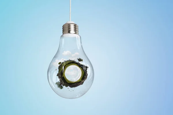 Зеленый изогнутый пейзаж внутри стеклянной лампочки — стоковое фото