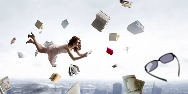 Young woman levitates while reading a book — Stock Photo, Image