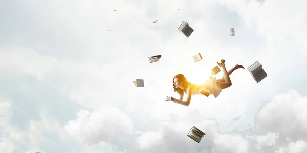 Young woman levitates while reading a book — Stock Photo, Image