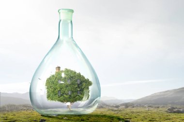 Yüzen cam bir şişenin içindeki ev.