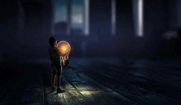 Boy with a glowing light bulb . Mixed media — Stock Photo, Image