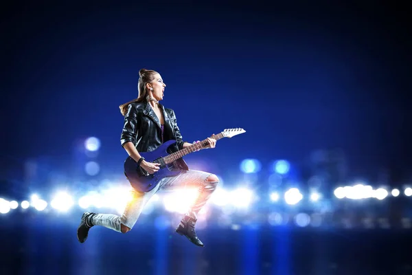 Young and beautiful rock girl playing the electric guitar — Stock Photo, Image