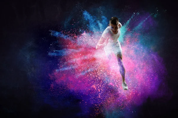 Portrait of a fitness man running on a colourful background . Mixed media — Stock Photo, Image