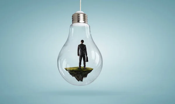 電球の中に立つビジネスマン — ストック写真