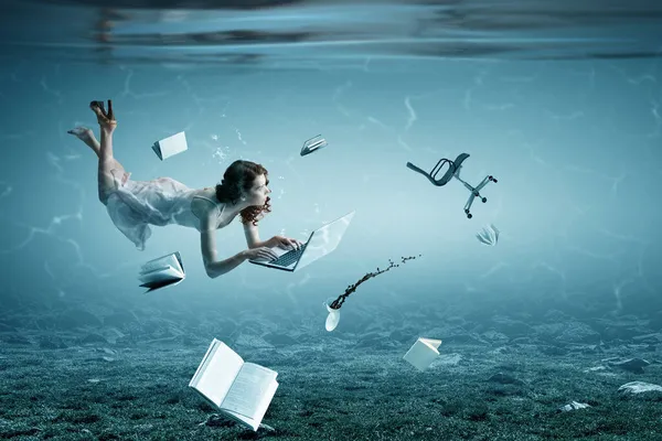 Woman with laptop underwater . Mixed media — Stock Photo, Image