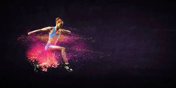 Young beautiful girl doing exercise against dark background — Stock Photo, Image