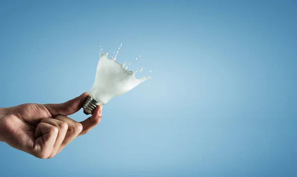 Light bulb with white glass splash — Stock Photo, Image