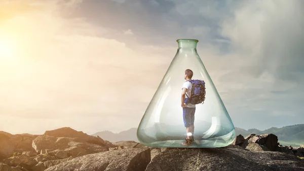 Young traveler inside glass bottle . Mixed media — Stock Photo, Image