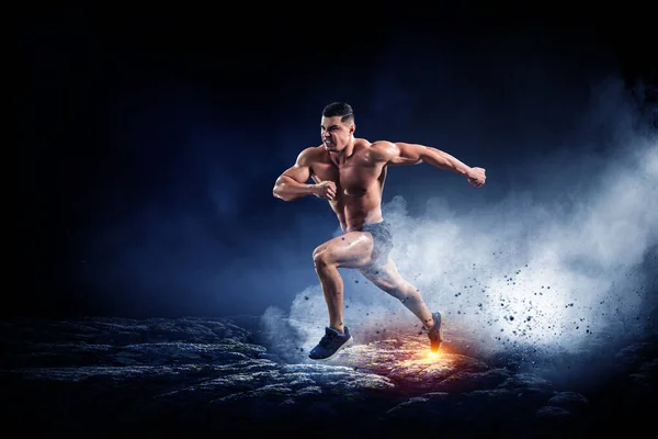 Male runner against dark background — Stock fotografie