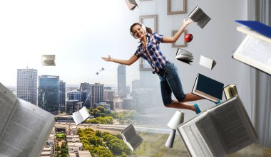 Kulaklık takan bir kadın zıplıyor. Karışık ortam