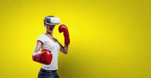 Young woman boxing in VR glasses . Mixed media — Stock Photo, Image