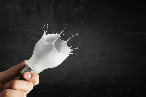 Light bulb with white glass splash — Stock Photo, Image