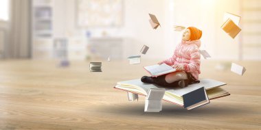Küçük kız kitap okuyor.